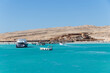 Hurghada, Egypt - September 23 2021: Orange Bay Beach with crystal clear azure water and boat ships with tourists