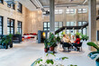 © Westend61 - Coworkers attending meeting at office lobby