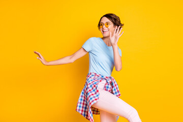 Poster - Photo portrait of cute girl dancing with shirt on waist isolated on vivid yellow colored background