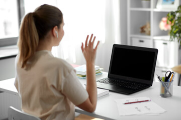 Poster - distant education, remote job and people concept - happy smiling female teacher with laptop computer having video call or online class at home office