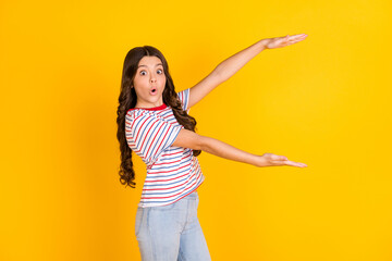 Wall Mural - Profile side photo of young girl amazed shocked surprised show hands big huge size isolated over yellow color background