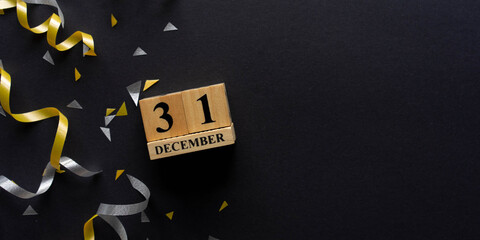 Wall Mural - close up number 31 december cube shape wood with gold and silver color of rolling ribbon and confett