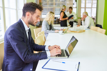 Businessman doing research on laptop computer