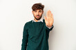 © Asier - Young mixed race man isolated on grey background standing with outstretched hand showing stop sign, preventing you.