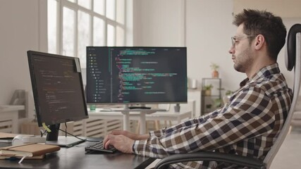 Wall Mural - side-view stab shot of professional system administrator or software developer writing program codes