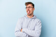 © Asier - Young caucasian man isolated on blue background funny and friendly sticking out tongue.