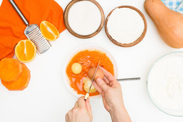 Wall Mural - step-by-step recipe for pumpkin curd casserole in the shape of a zebra, orange autumn pie with orange. mixing ingredients for pumpkin pie top view