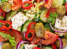 Greek Salad Of Fresh  Tomato, Sweet Pepper, Cucumber, Red Onion, Feta Cheese And Green Olives. Healthy Vegetarian Food. Background, Texture