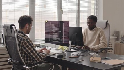 Wall Mural - stab shot of team of multi-ethnic it professionals developing new software on pc sitting in contempo