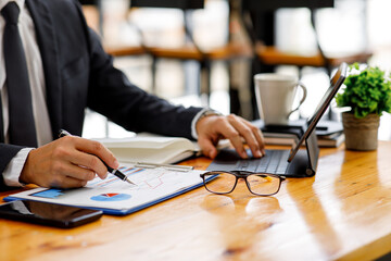 Businessman working at office with documents on his desk, doing planning analyzing the financial report, business plan investment, finance analysis concept