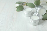 Fototapeta  - Eco lip balm and leaves on white wooden background