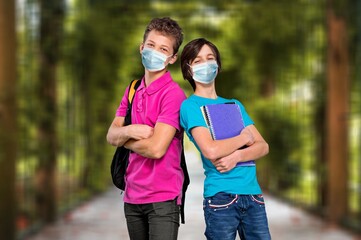 Poster - Happy secondary students in school. Young male and female carrying backpack outdoor