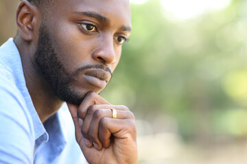 Worried husband with black skin thinking looking away