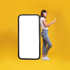 Wall Mural - woman leaning on white empty smartphone screen and using phone