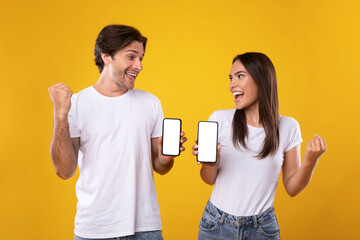 Happy excited lady using mobile phone at studio, saying yes
