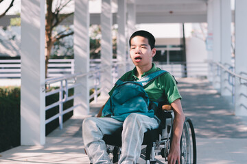 Wall Mural - sian special child on wheelchair is smiling face as happiness on ramp for disabled people background in hospital, Lifestyle in the education age of disabled children, Happy disability kid concept.