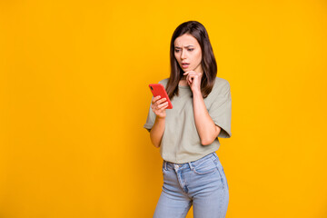Wall Mural - photo of young lovely pretty serious thoughtful minded girl thinking about dislike in phone isolated