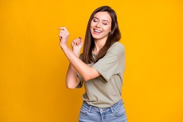 Sticker - Photo of young attractive lovely smiling cheerful positive dreamy girl dancing isolated on yellow color background