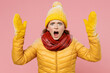 © ViDi Studio - Displeased irritated dissatisfied young woman 20s years old wears yellow jacket hat mittens look camera scream gesticulating with hands isolated on plain pastel light pink background studio portrait.