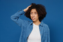 Young Sad Unhappy Confused Puzzled Black Woman 20s In Casual Clothes Shirt White T-shirt Look Aside Hold Scratch Head Isolated On Plain Dark Blue Background Studio Portrait. People Lifestyle Concept.