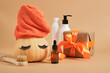 pumpkin with towel and false eyelashes, cosmetics bottles, gift box with ribbon and alarm clock