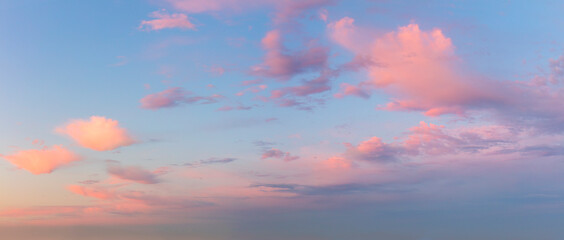 Wall Mural - pastel gentle pink clouds in the blue sky during dawn sunset, sundown backgroung