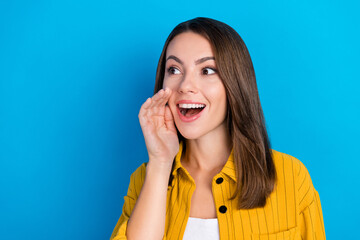 Poster - Photo of cute young chatterbox lady tell secret wear yellow shirt isolated on blue color background