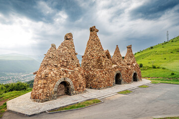 Wall Mural - Monument near the road, dedicated to ancient cave dwellings carved out of soft volcanic tuff rocks, that is the main attraction of Goris town in Armenia.