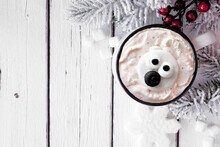 Hot Chocolate With Polar Bear Marshmallows. Above View Table Scene With Christmas Corner Border Against A White Wood Background. Copy Space.