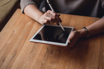 Young girl works on the tablet on the internet and goes to the train, ipad surfing, woman using smartphone, holding tablet in hand, send answer texts, travel in train, office manager, hipster