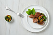 © boomeart - Top view of fried frozen veal meatballs on a plate