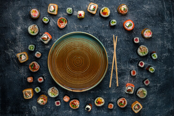 Wall Mural - Set of traditional japanese food on a dark background. Sushi rolls Asian food frame.