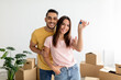 © Prostock-studio - Happy multiracial couple showing house key, moving to new apartment together