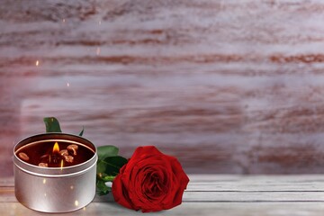 Canvas Print - The concept of remembrance, funerals, and condolences. Candle and red rose on the desk