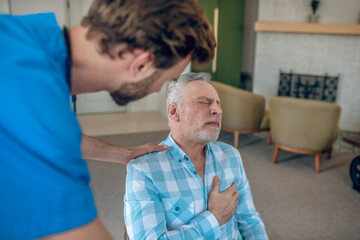 Cardiologist providing first aid to a patient with a heart attack