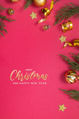 Wall Mural - merry christmas inscription on red background with decorative elements and green branches flat lay
