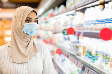 Wall Mural - Portrait Of Muslim Woman In Supermarket, Wearing Hijab And Mask