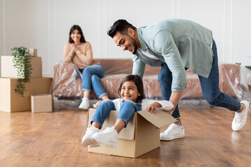 Canvas Print - Happy middle eastern family riding in cardboard box