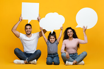 Diverse Opinions. Arab Mom, Dad And Little Daughter Holding Empty Speech Bubbles