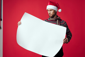 Wall Mural - Cheerful man in a christmas white mockup poster red background