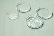 © kaiqiang - Petri dishes with water and ripple in green background