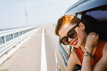 Wall Mural - pretty woman in sunglasses rides in a travel car