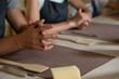 © Natalia Navodnaia - Hands of people working in pottery workshop