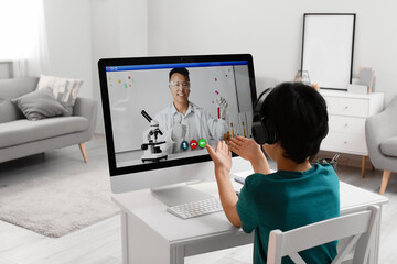 Canvas Print - Little boy studying Chemistry online at home