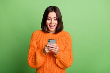 Wall Mural - portrait of attractive cheerful amazed girl using device gadget app smm post isolated over bright gr