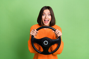 Wall Mural - portrait of attractive cheerful amazed girl holding steering wheel traveling having fun fast speed i