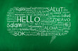 Hello in different languages in speech bubble on chalkboard