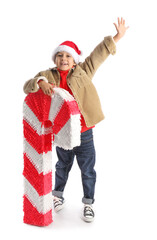 Sticker - Cute little boy with candy cane pinata on white background