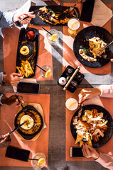 Top view on a dinner table with food in restaurant.