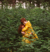 Cute Little Redhead Brother And Sister Embracing In Lush Green Forest